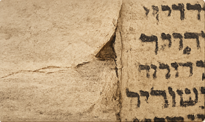 Torah scroll parchment damage and wear affecting kosher status